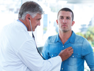 doctor checking the heart of man