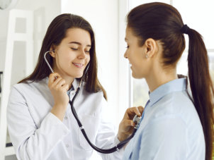 doctor checking the heart of woman