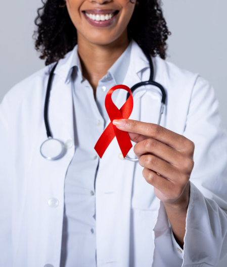 doctor holding a red aids ribbon